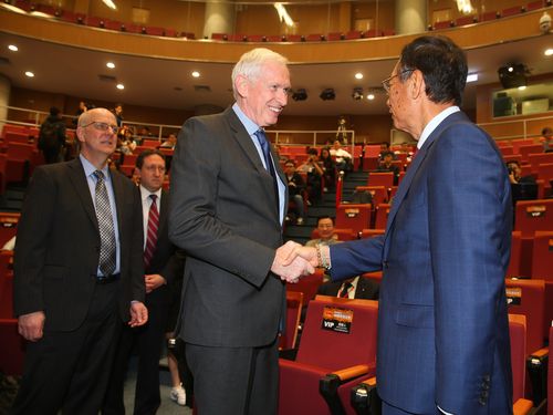 AIT Chairman James Moriarty (left) shakes hands with Hon Hai Precision Industry Co. founder Terry Gou.