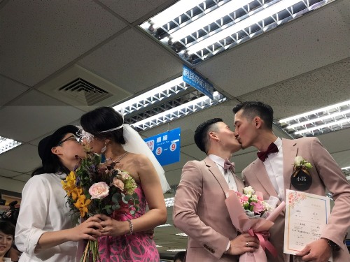 Gay couples register to get married on May 24, the first day same-sex marriage becomes legal in Taiwan.