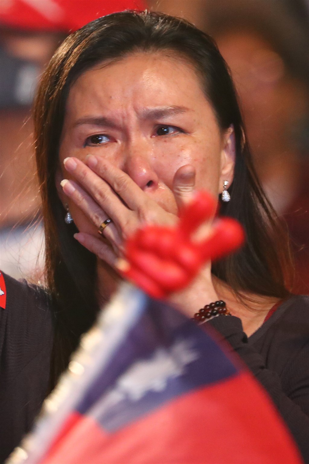 A Han supporter sheds tears at the outcome of the presidential election.
