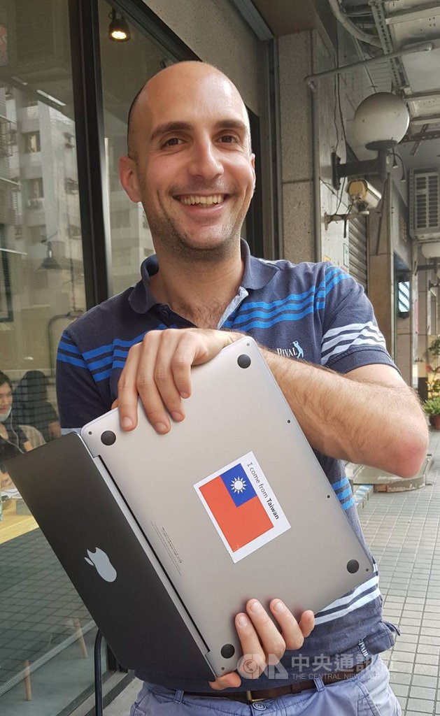 Chen Hsi-wen shows off his laptop that has a sticker of the Republic of China (Taiwan) flag on it.