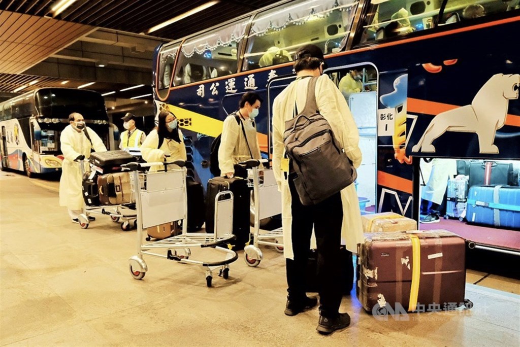 Passengers returning from India get ready to get on the buses that will take them to quarantine.