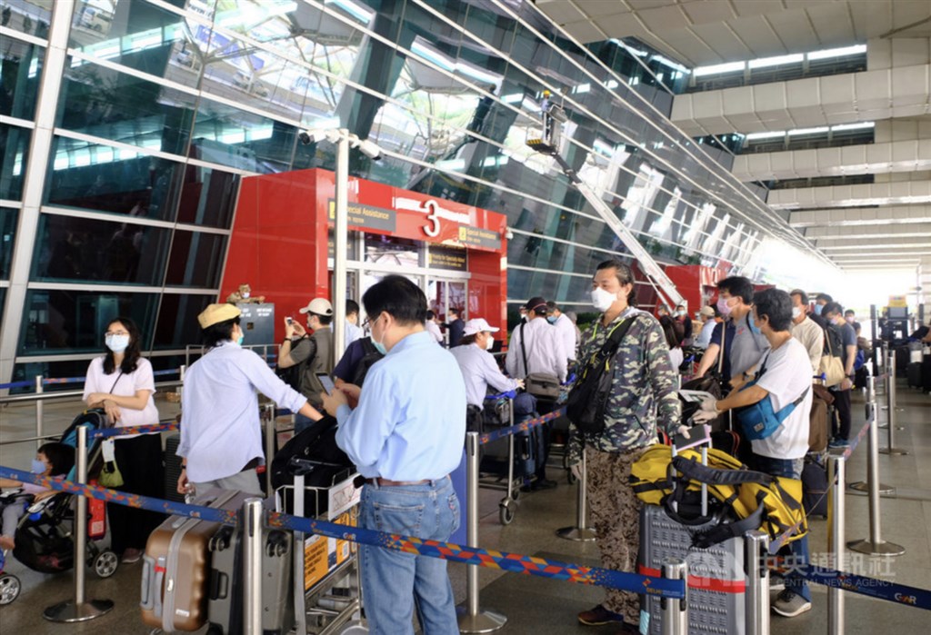 Passengers prepare to enter the airport in New Delhi.