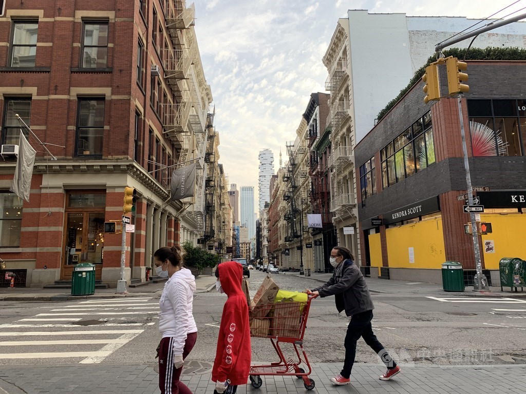 People wear masks while walking on the streets of New York City