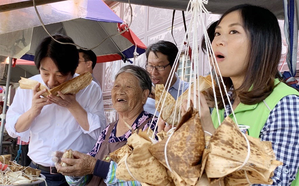 Vice President Lai Ching-te (left) tries a zhongzi during a visit in New Taipei. / CNA photo June 23