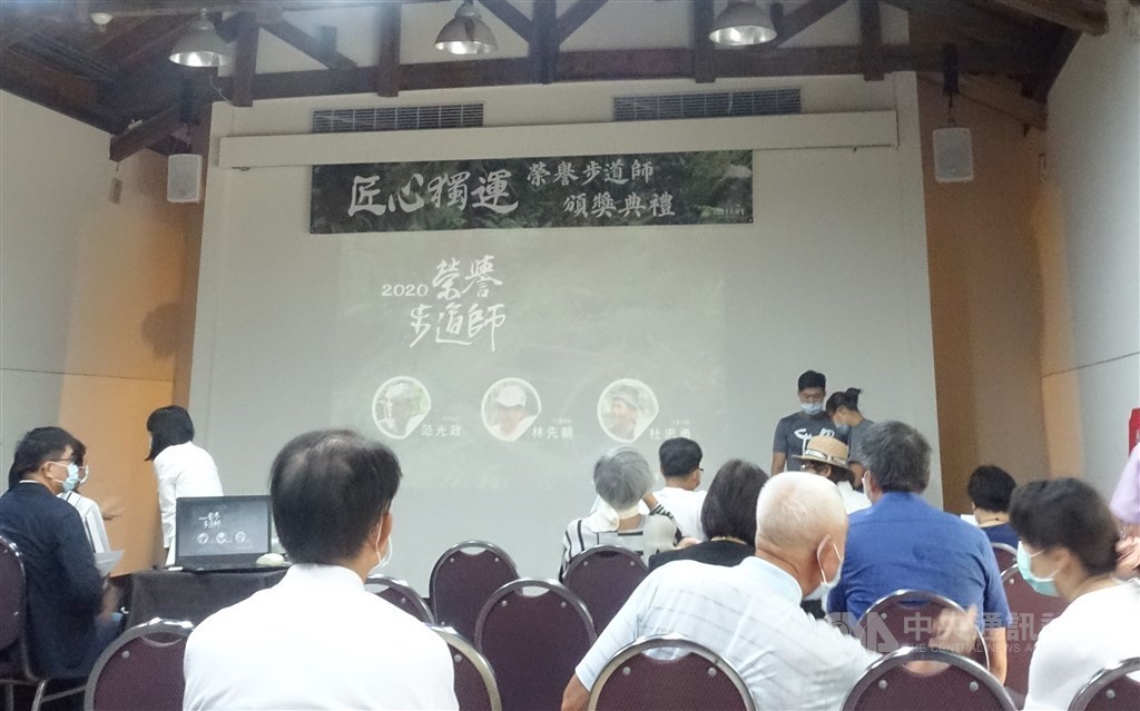 The names of the three trail builders are seen on screen at the ceremony. CNA photo Aug. 9, 2020