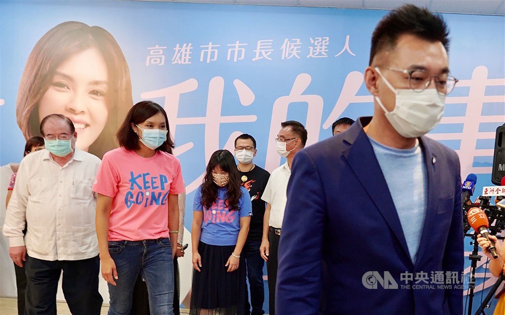 KMT Chairman Johnny Chiang (right) leaves the campaign headquarters after the party