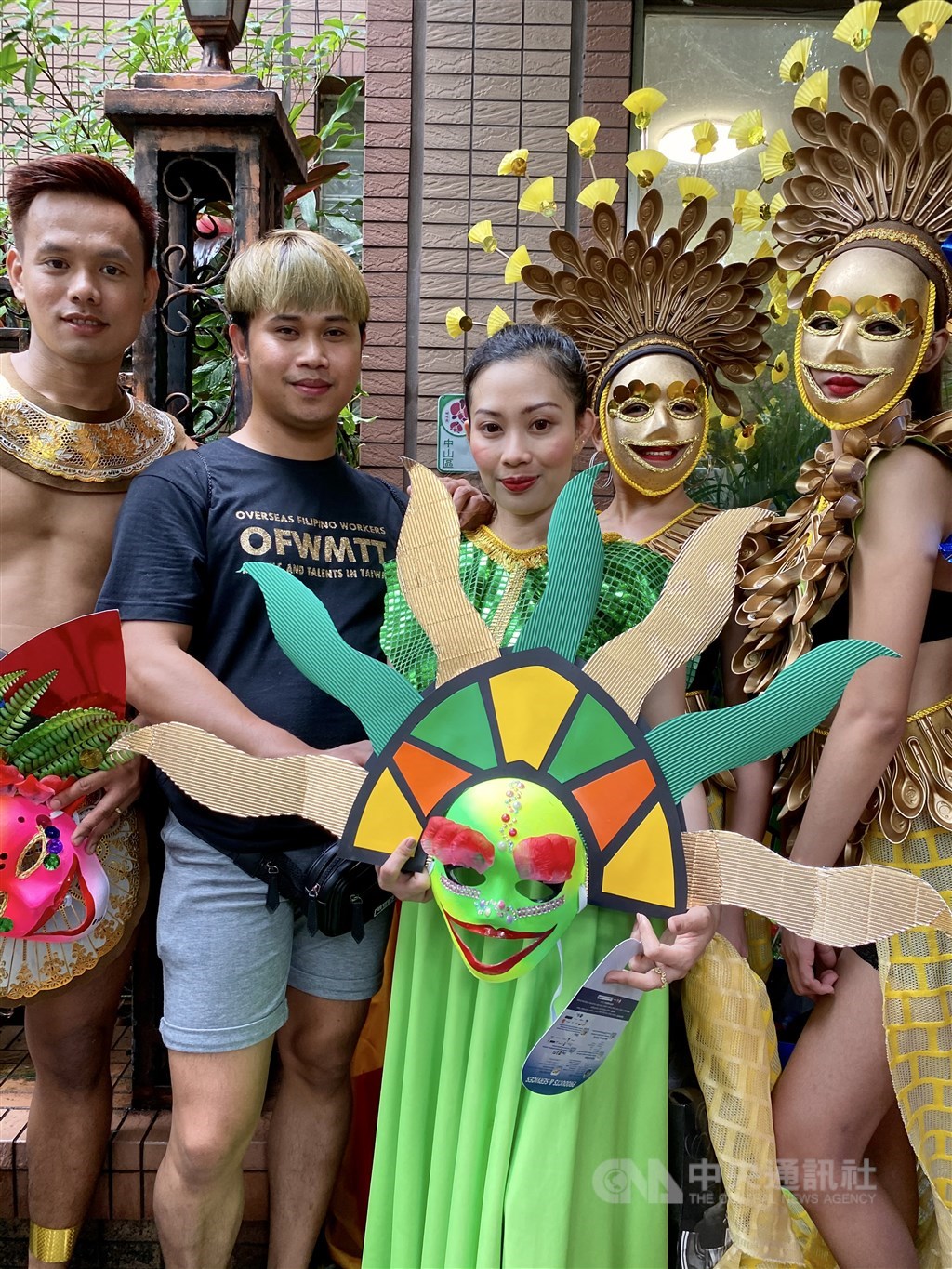 Mark Lester Reyes (second left) poses with people wearing costumes that he made for the festival. CNA photo Sept. 20, 2020