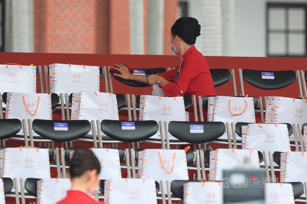 The greeting team members sanitize the seating area before guests arrive. CNA photo Oct. 10, 2020