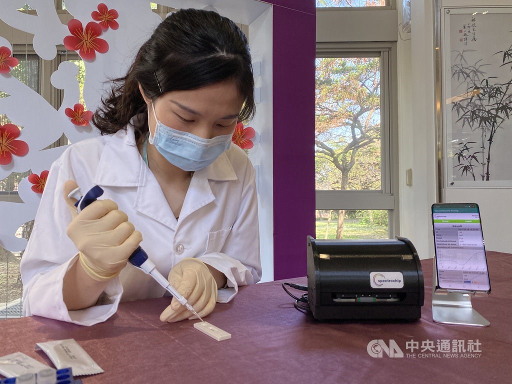 A researcher performs a demonstration of the rapid tester during a press event held Thursday / CNA photo Feb. 18, 2021
