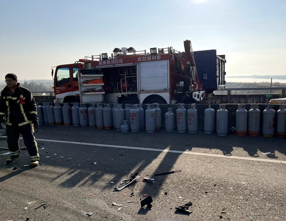 Firefighters line up liquefied petroleum gas tanks that had scattered after the accident. Photo courtesy of the Chiayi County Fire Bureau, Jan. 21, 2021