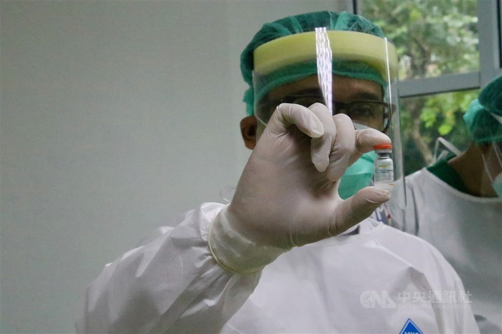 An Indonesian doctor holds a vial of China