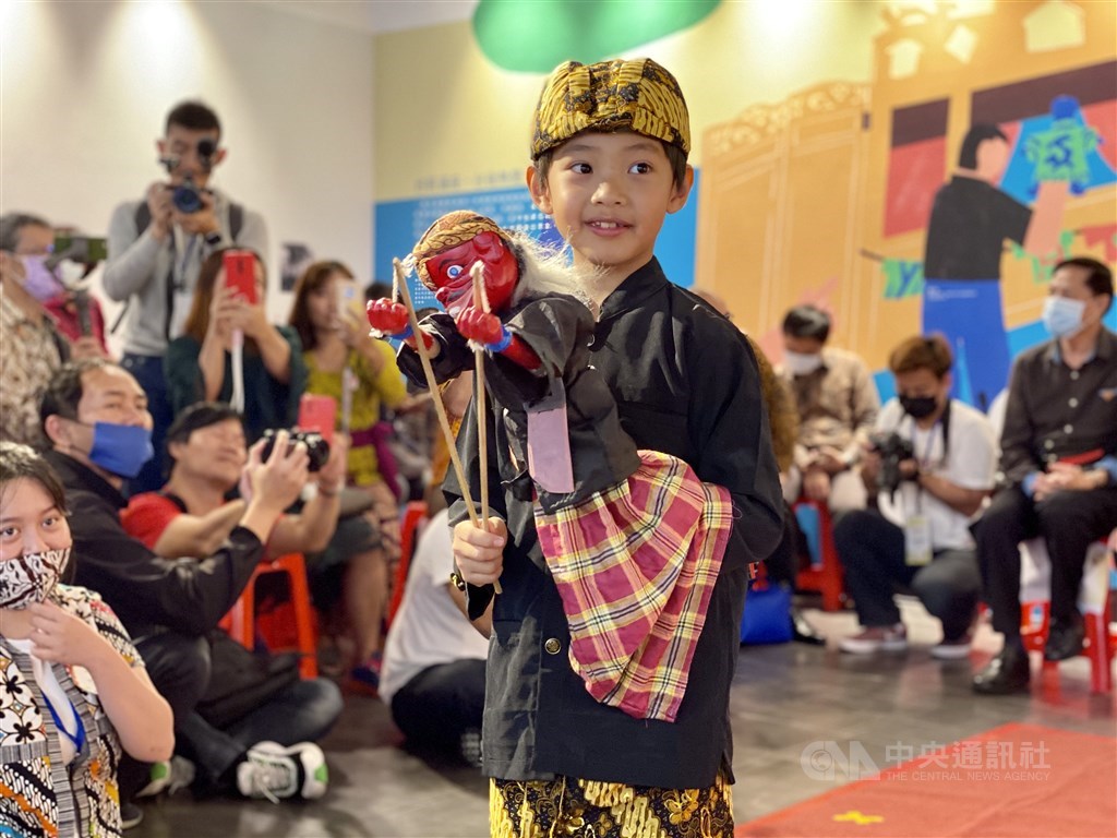 A young boy holds a traditional Indonesian puppet. CNA photo April 11, 2021