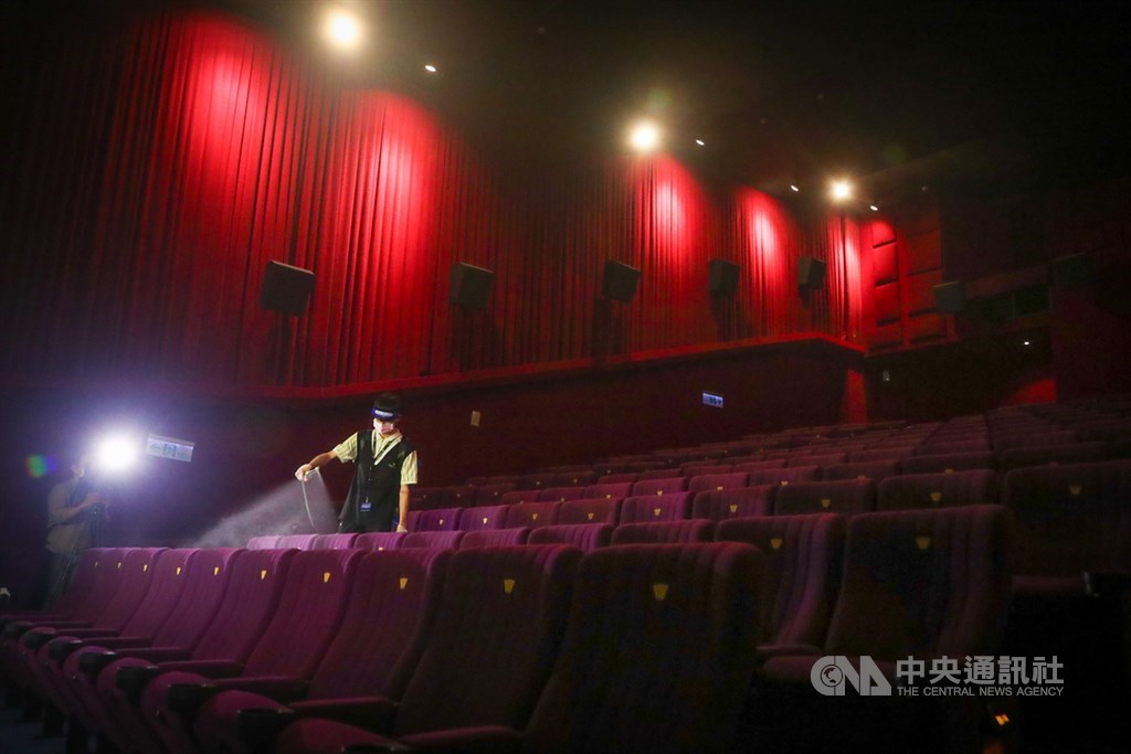 An employee at a movie theater in Taipei disinfects seats between showings. CNA file photo