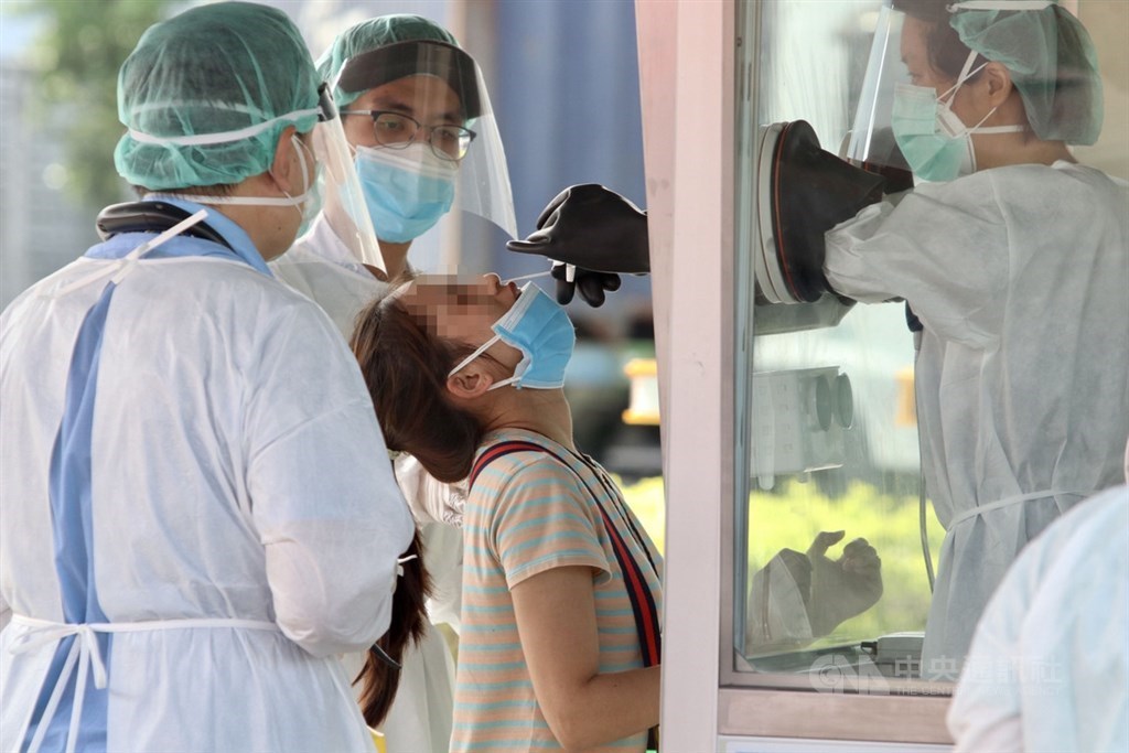 A migrant worker takes a COVID-19 test. CNA file photo