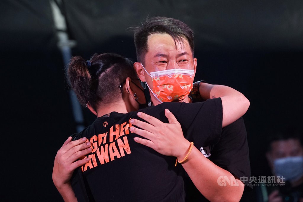 Outgoing Legislator Chen Po-wei (right) receives a hug from a supporter after conceding in the recall vote in Taichung Saturday. CNA photo Oct. 23, 2021