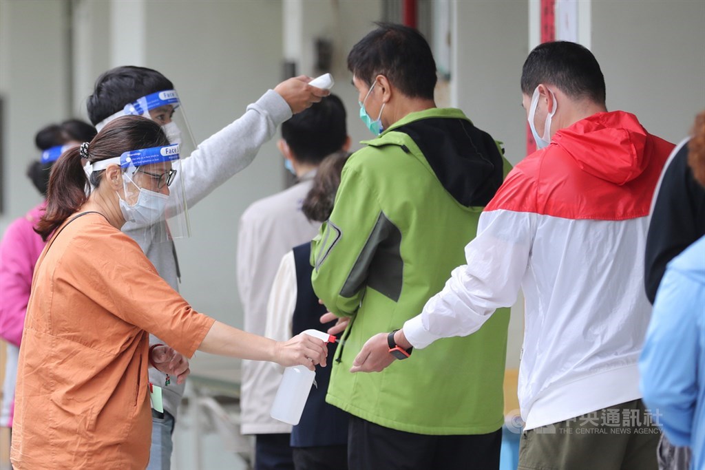 Election officials in Taichung check voters