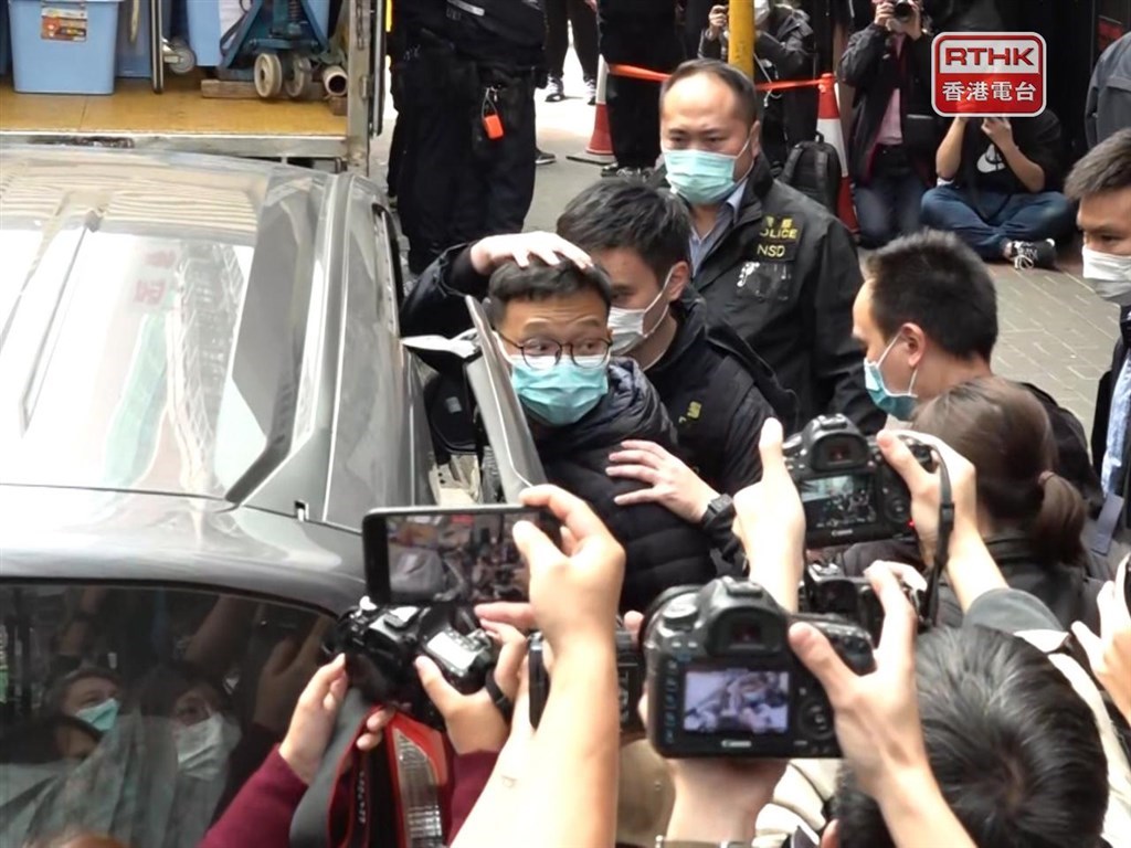 Stand News Acting Editor in Chief Patrick Lam (center, in glasses) is pictured when he was taken to the news outlet