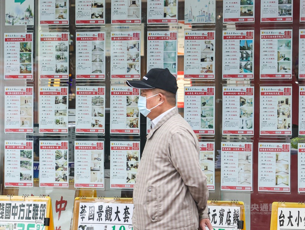 A man walk past by a real estate agent. CNA file photo