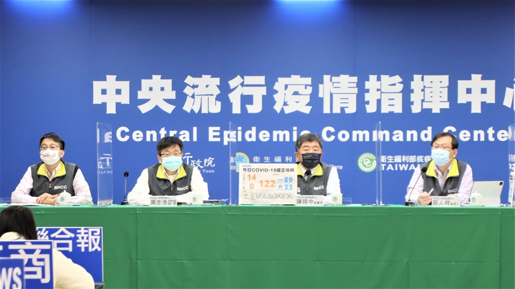 Health Minister Chen Shih-chung (second right) holds Friday