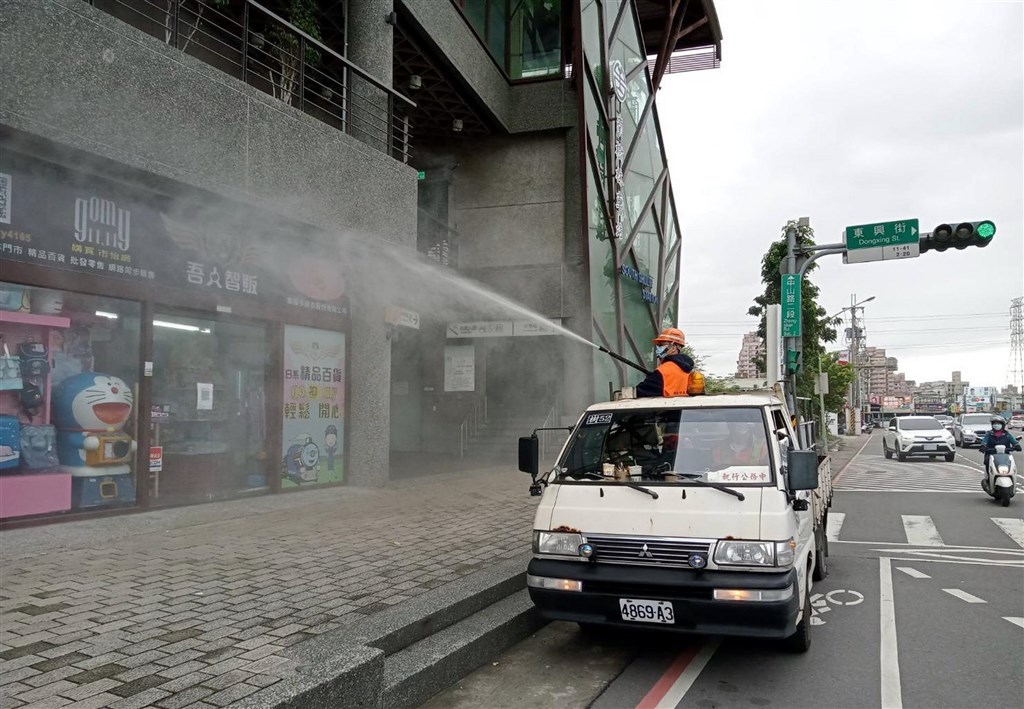 A worker sprays sanitizers in an area in New Taipei