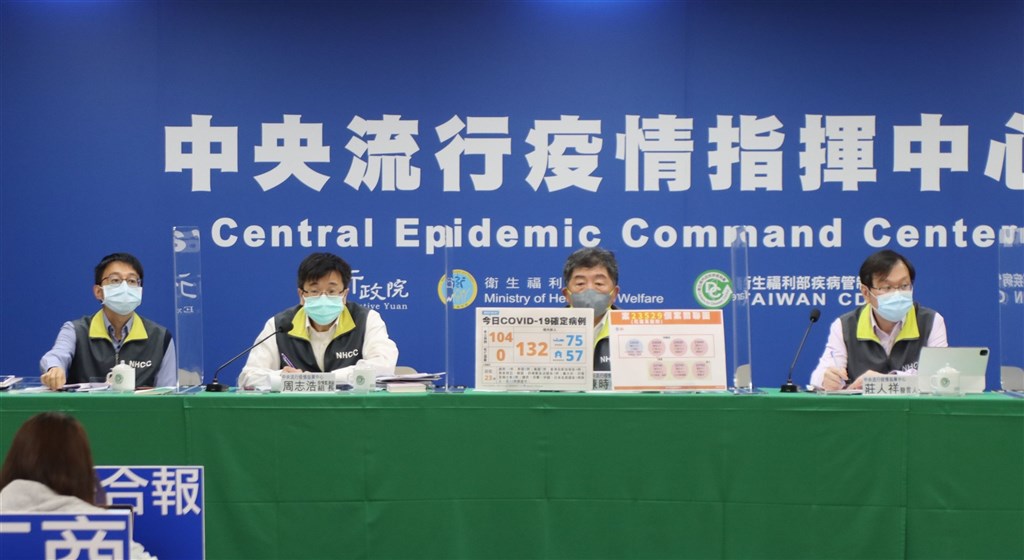 Health Minister Chen Shih-chung (second right) holds Friday