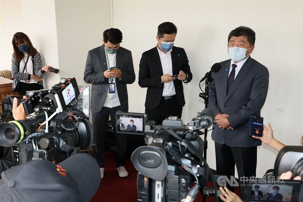 Minister of Health and Welfare Chen Shih-chung (right) takes questions from reporters in Taipei in May. CNA file photo