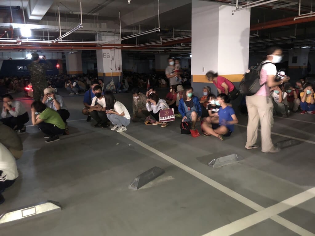 People take shelter in a parking lot during this year
