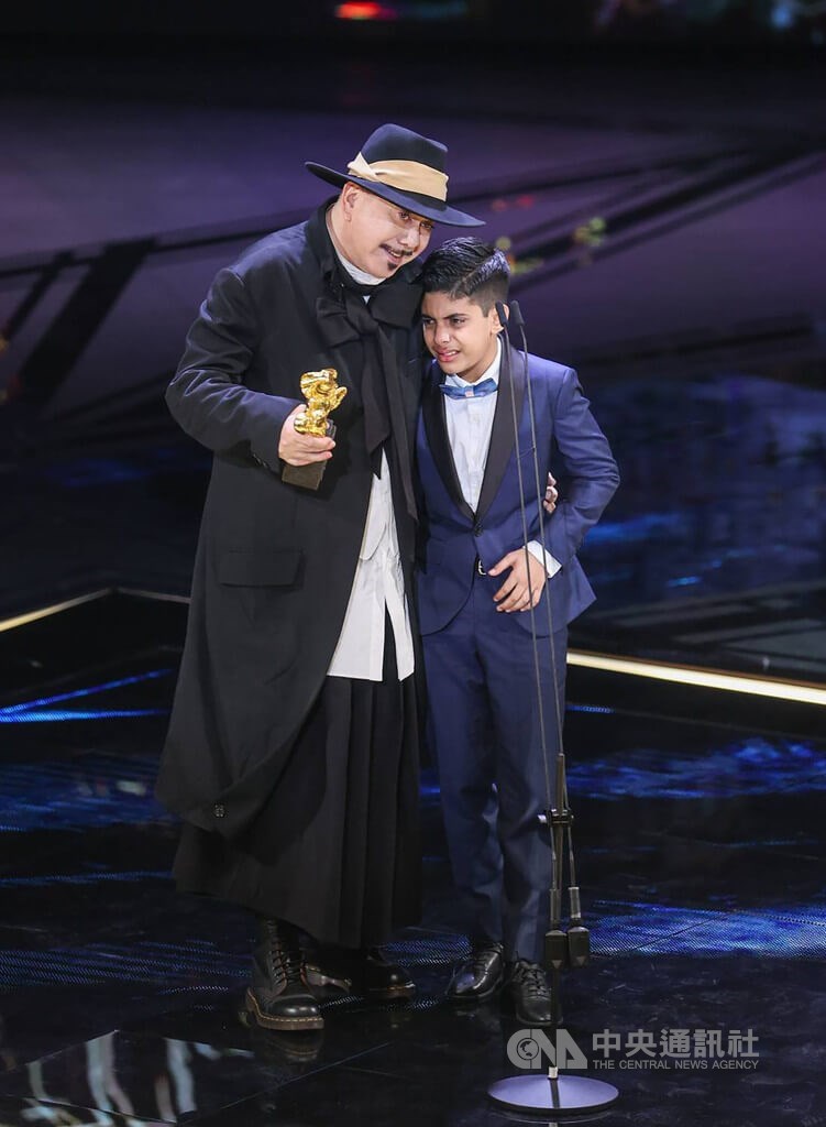 Anthony Wong (left) and his young co-star Sahal Zaman hold each other on the stage after the Hong Kong actor received the best leading actor award at Saturday