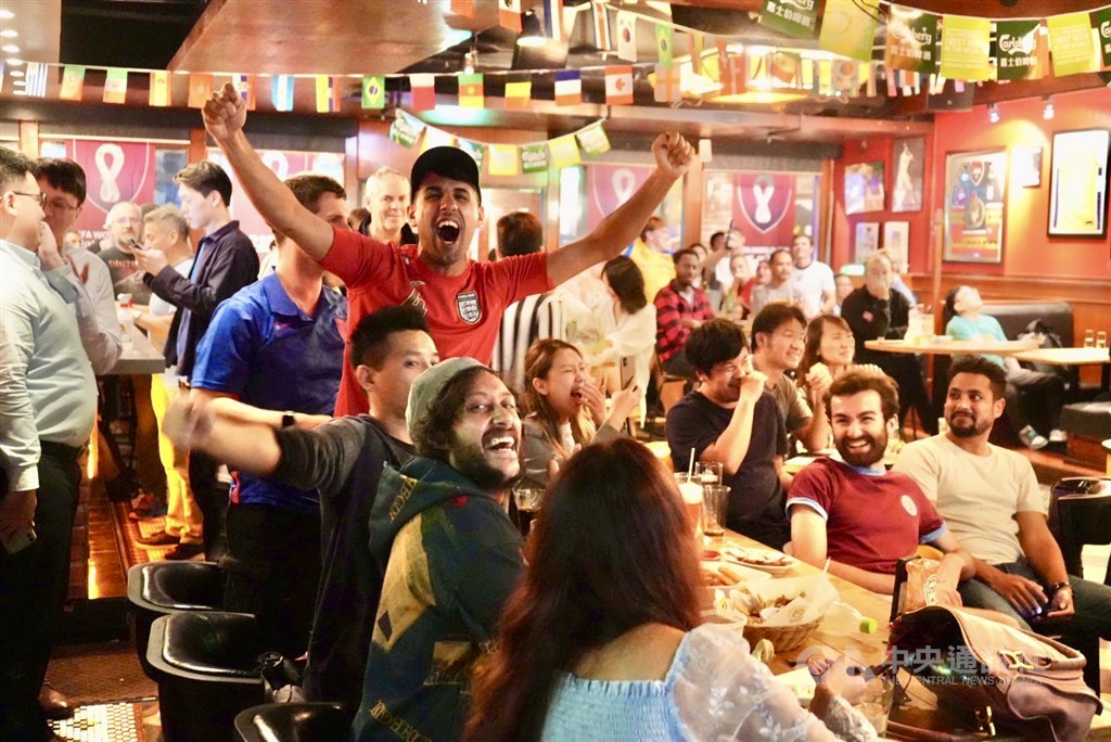 Sports fans celebrate after a goal. CNA photo Nov. 21, 2022