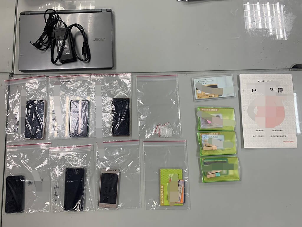 Smartphones, bank or post office passbooks and other items seized during the raid for the police investigation are displayed in this undated police photo.