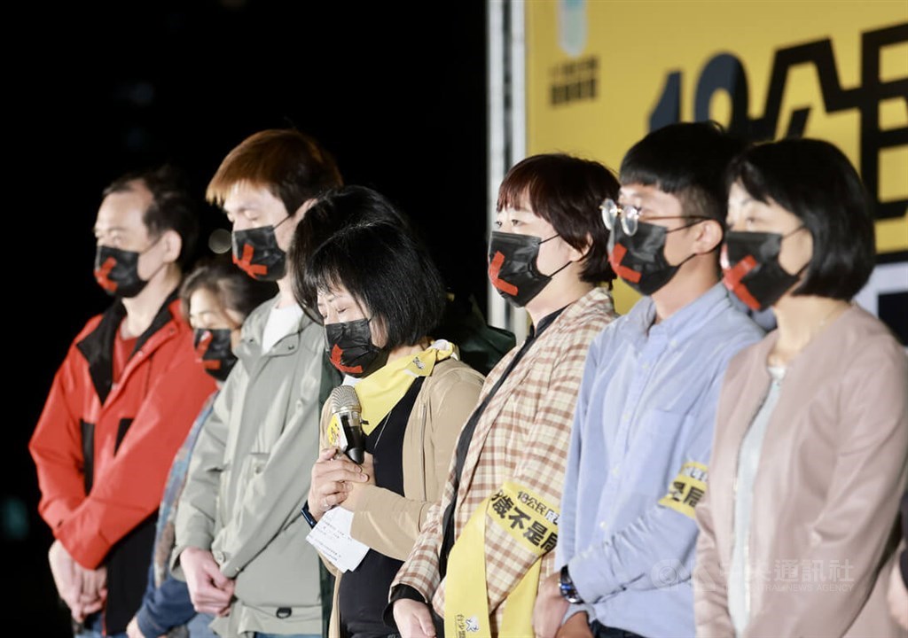 Civic groups pushing for lowering the voting age from 20 to 18 wear face masks reflecting their regrets over the failed referendum on a proposed constitutional amendment in Taipei Saturday evening. CNA photo Nov. 26, 2022