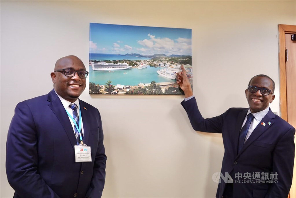 Prime Minister of Saint Lucia Philip J. Pierre (right) and Education Minister Shawn Edward. Pierre points to the location of his office in a large photograph of the Saint Lucian capital city of Castries. CNA photo Nov. 30, 2022
