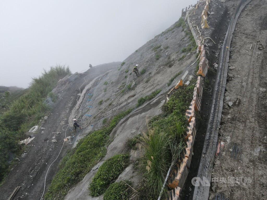 Workers use cables to move up and down a mountain slope along the eastern section of the Southern Cross-Island Highway in Taitung County on April 29 as they work to stabilize it to prevent rockslides. The highway was badly damaged during Typhoon Morakot in August 2009 and was reopened on May 1.