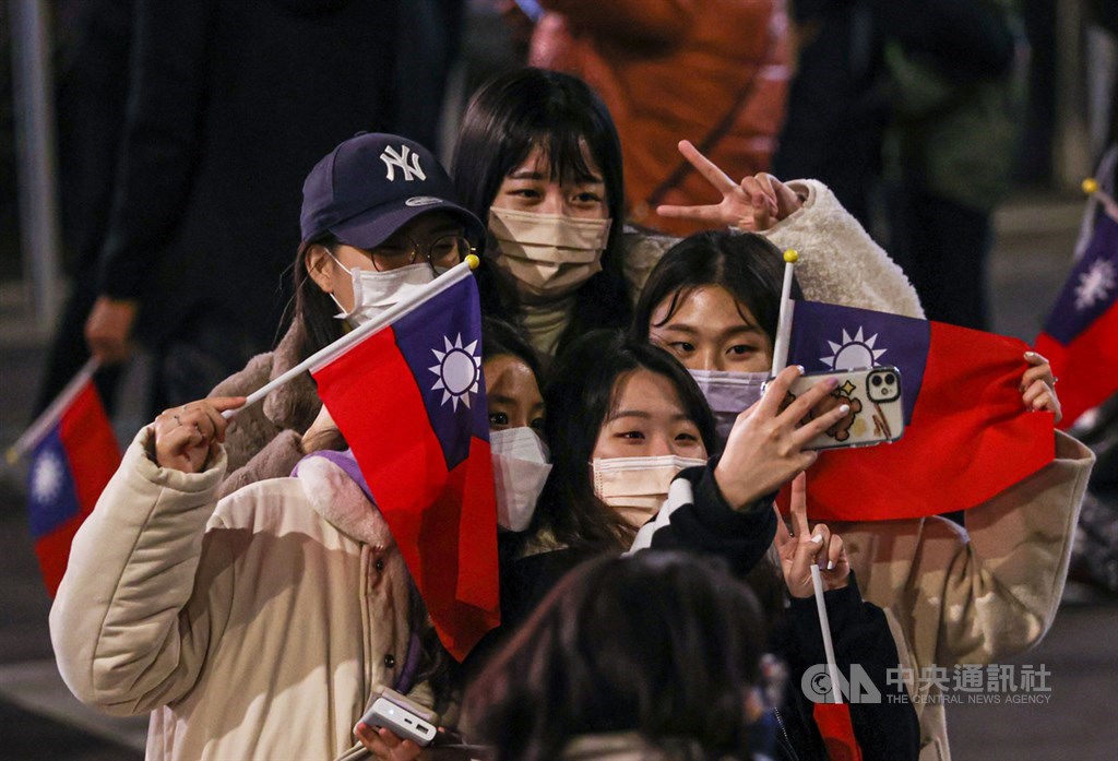 People pose for a selfie when attending the flag raising ceremony in front of the Presidential Office in Taipei on Jan. 1.