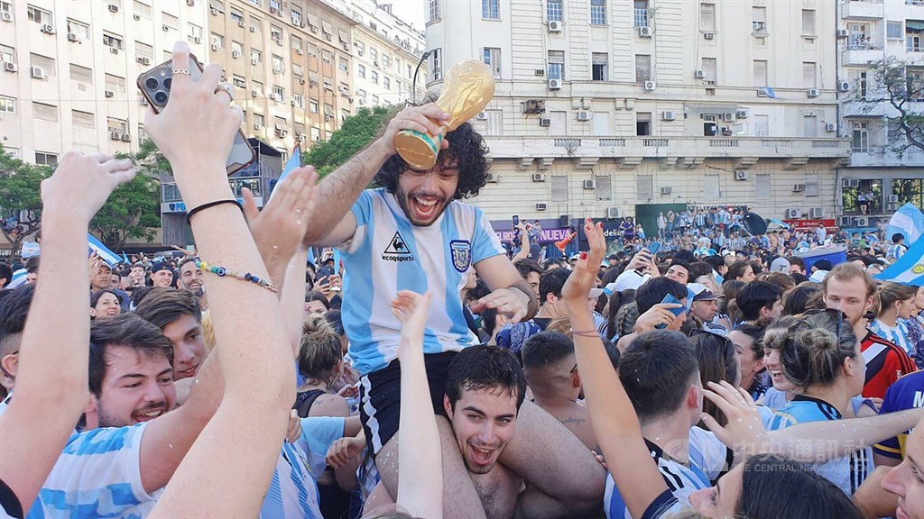Fans in Buenos Aires celebrate in the capital city of Argentina on Dec. 18 after the country