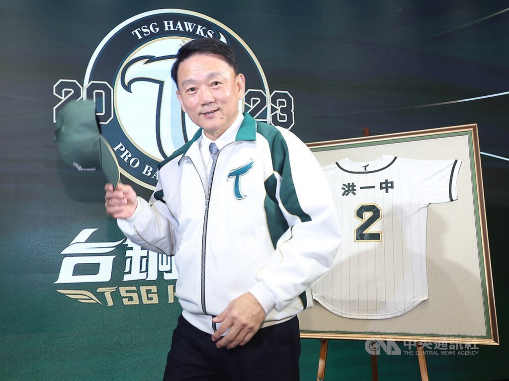 Hong I-chung poses for pictures in front of his TSG Hawks jersey displayed at Monday