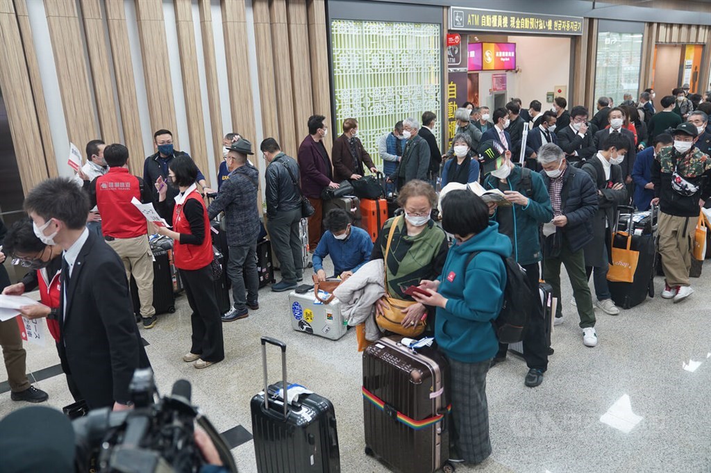 Passengers arrive at Taipei Songshan Airport on a flight from Japan