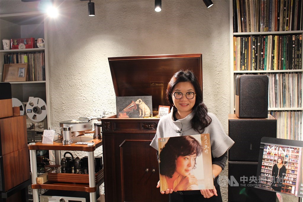 Sounds Good founder Lin Pei-ju holds up a copy of the late Taiwanese singer Teresa Teng
