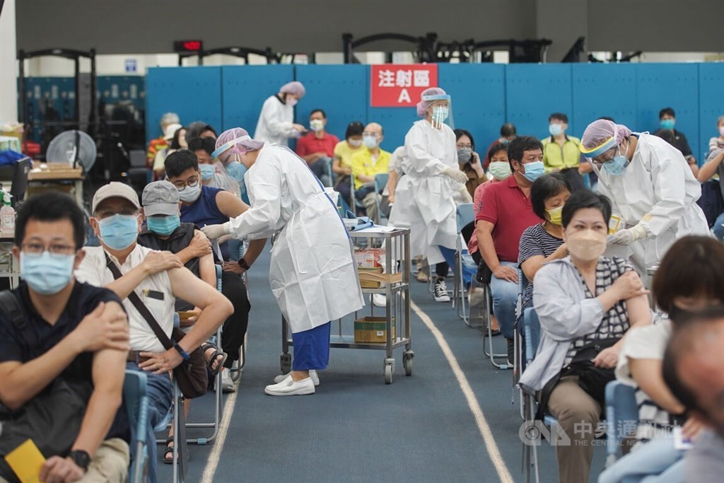 People receive a COVID-19 vaccine shot at a mass vaccination site set up at Taipei Stadium in November. CNA file photo