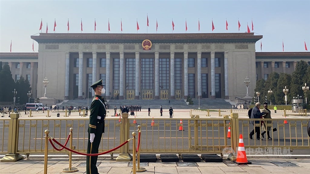 A Chinese armed policeman stands guard near the Great Hall of the People in Beijing in early March when China