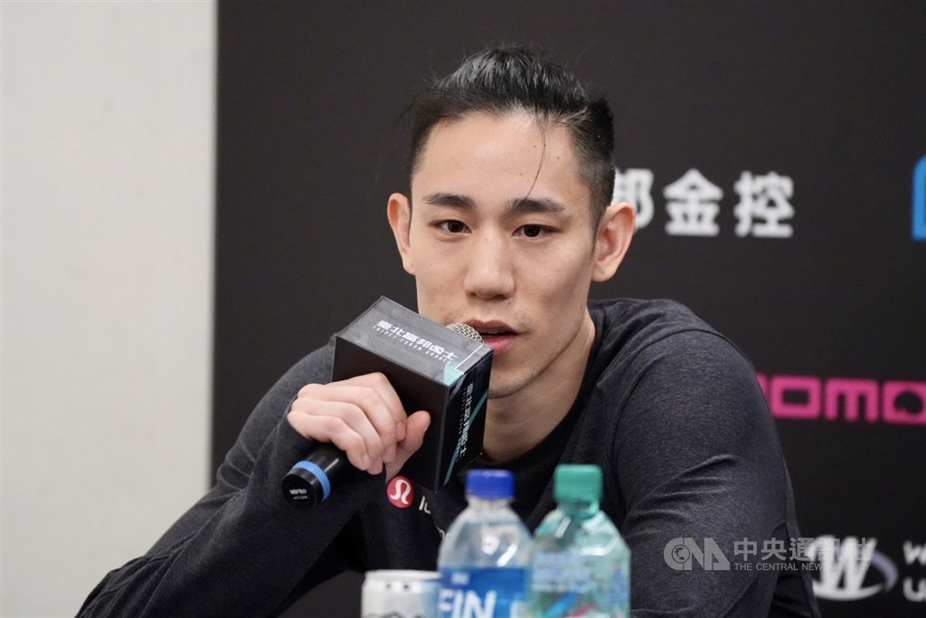 Joseph Lin speaks at the postgame press conference for Saturday
