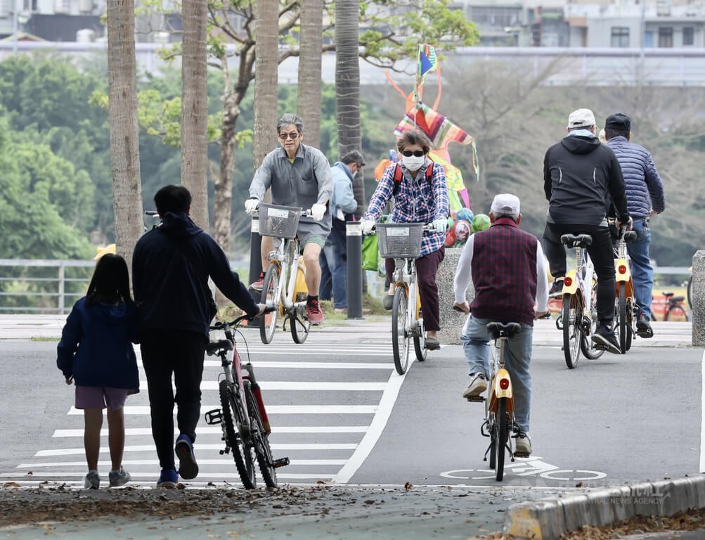 People cycle at a riverside park in Taipei on Sunday. CNA photo March 19, 2023