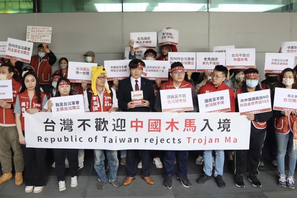 Protesters hold banners and placards in a rally organized by the Taiwan Statebuilding Party outside Taiwan Taoyuan International Airport