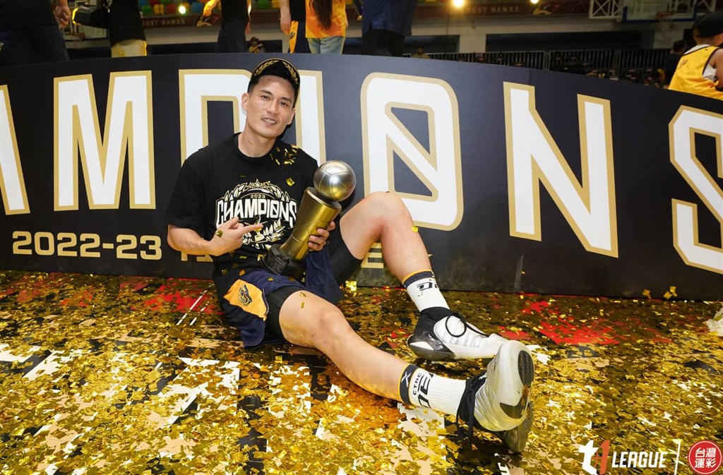 DEA point guard Lin Wei-han sits on the floor while holding the finals MVP trophy after Sunday