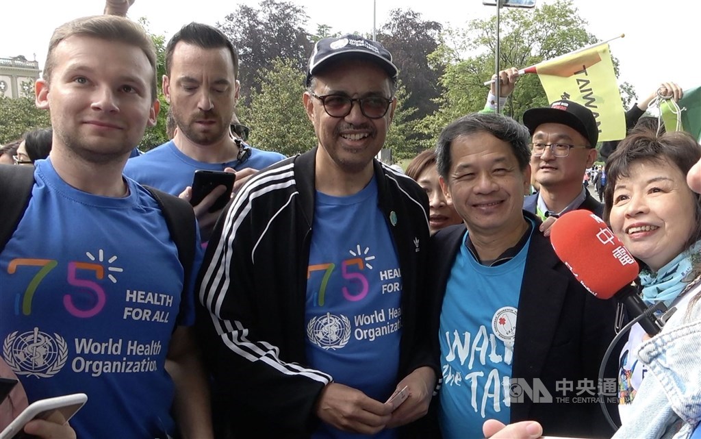 World Health Organization Director-General Tedros Adhanom Ghebreyesus (center left) and Taiwan