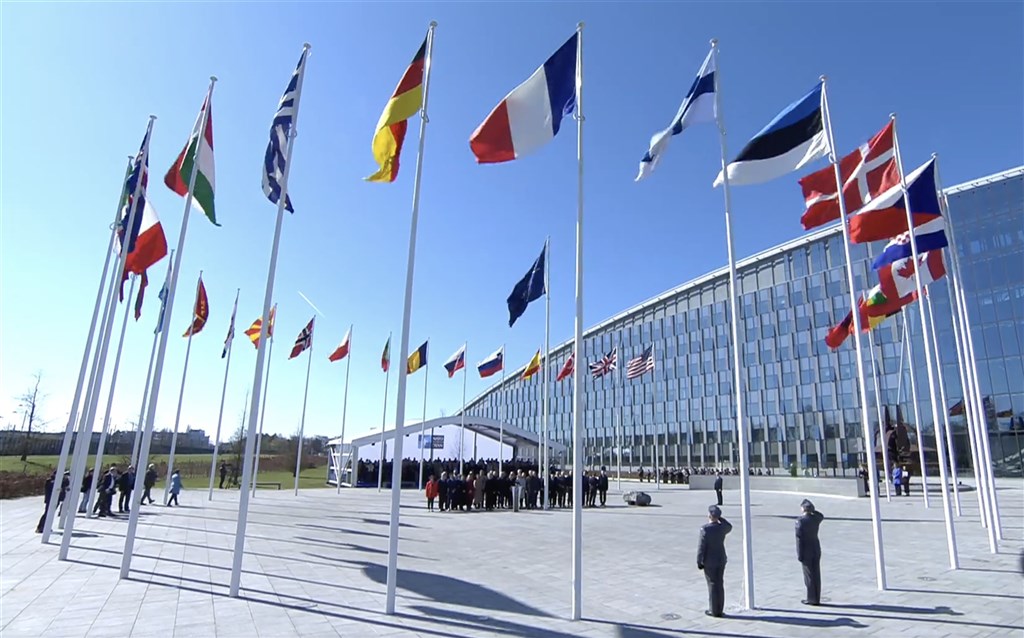 National flags of NATO member states, including its new member, Finland are raised in front of the organization