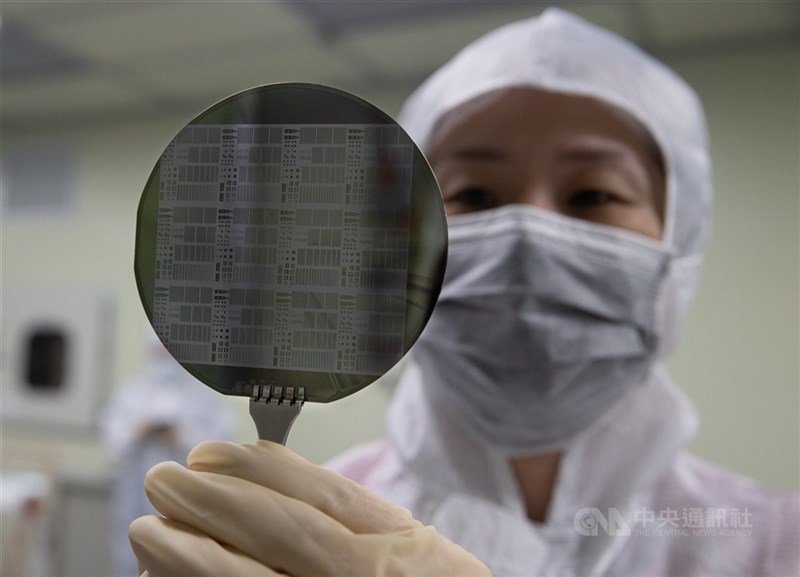 An engineer at a Taiwanese tech firm inspects a silicon wafer. CNA file photo