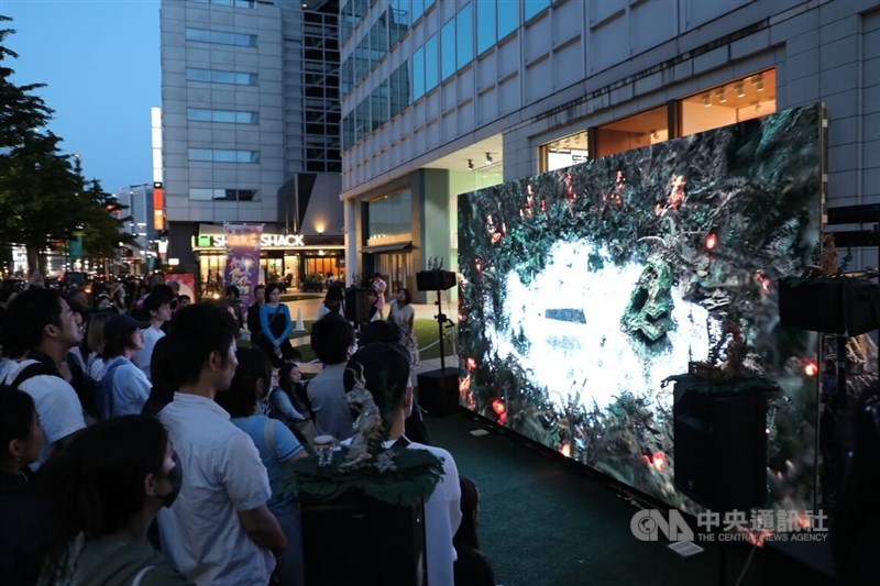 Visitors to the Roppongi Art Night in Tokyo watch Taiwanese artist Zhang Xu Zhan
