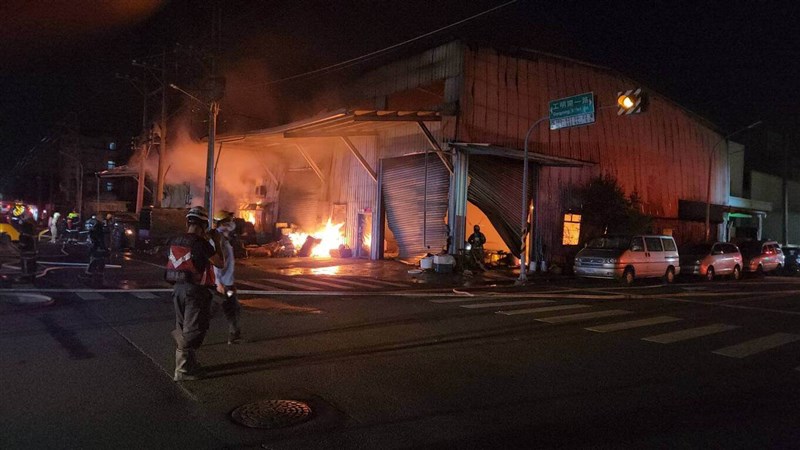 Firefighters work on putting out a fire at factories in Tainan