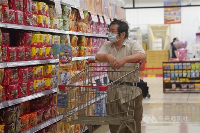 A shopper passes a shelf stacked with instant noodles at a Taipei supermarket in this undated photo. CNA file photo